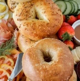 Colorful and inviting bagel charcuterie board with assorted toppings and spreads.