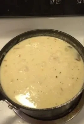 Bowl of Copycat Skippers Clam Chowder garnished with parsley and served with bread