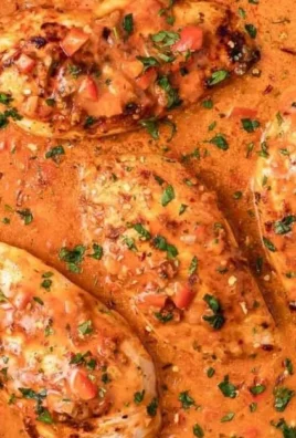 Creamy peri peri chicken skillet served in a cast iron pan with vibrant sauce.