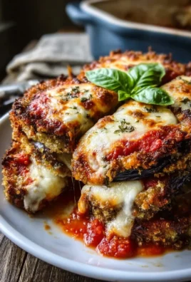 Crispy Baked Eggplant Parmesan dish topped with fresh basil and cheese