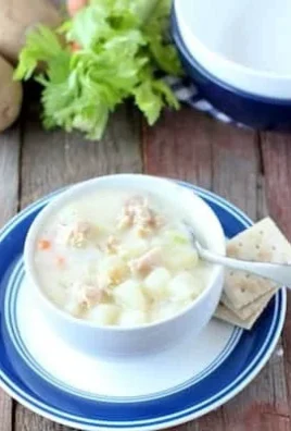 Delicious bowl of easy clam chowder with ingredients and seasonings