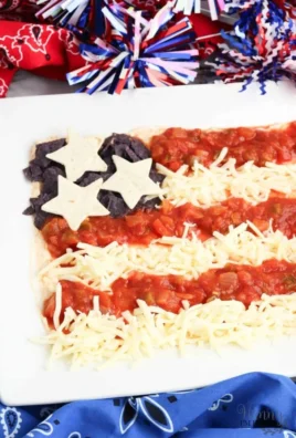 Colorful flag taco dip garnished with fresh toppings