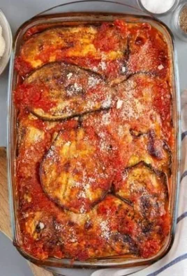 Low carb eggplant parmesan served on a plate with fresh basil